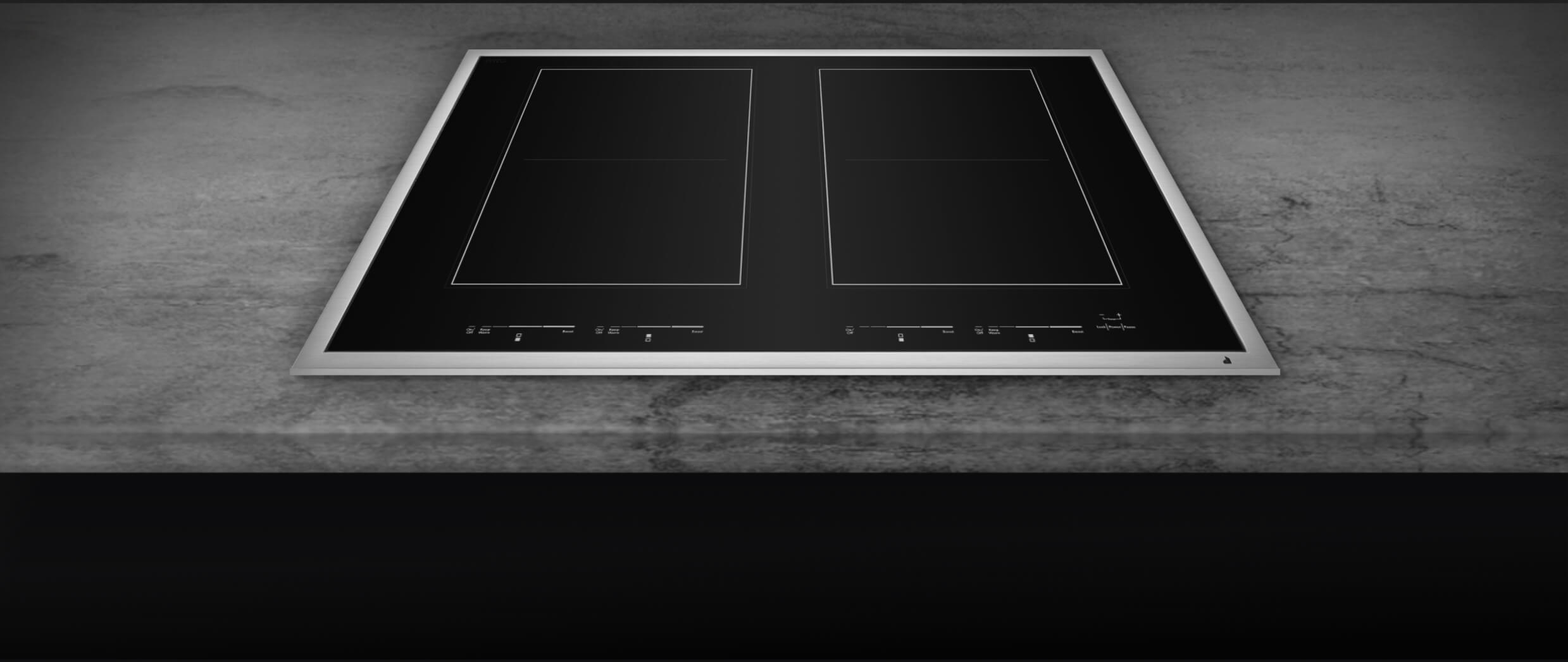 A closeup of the brushed metal frame of a cooktop.