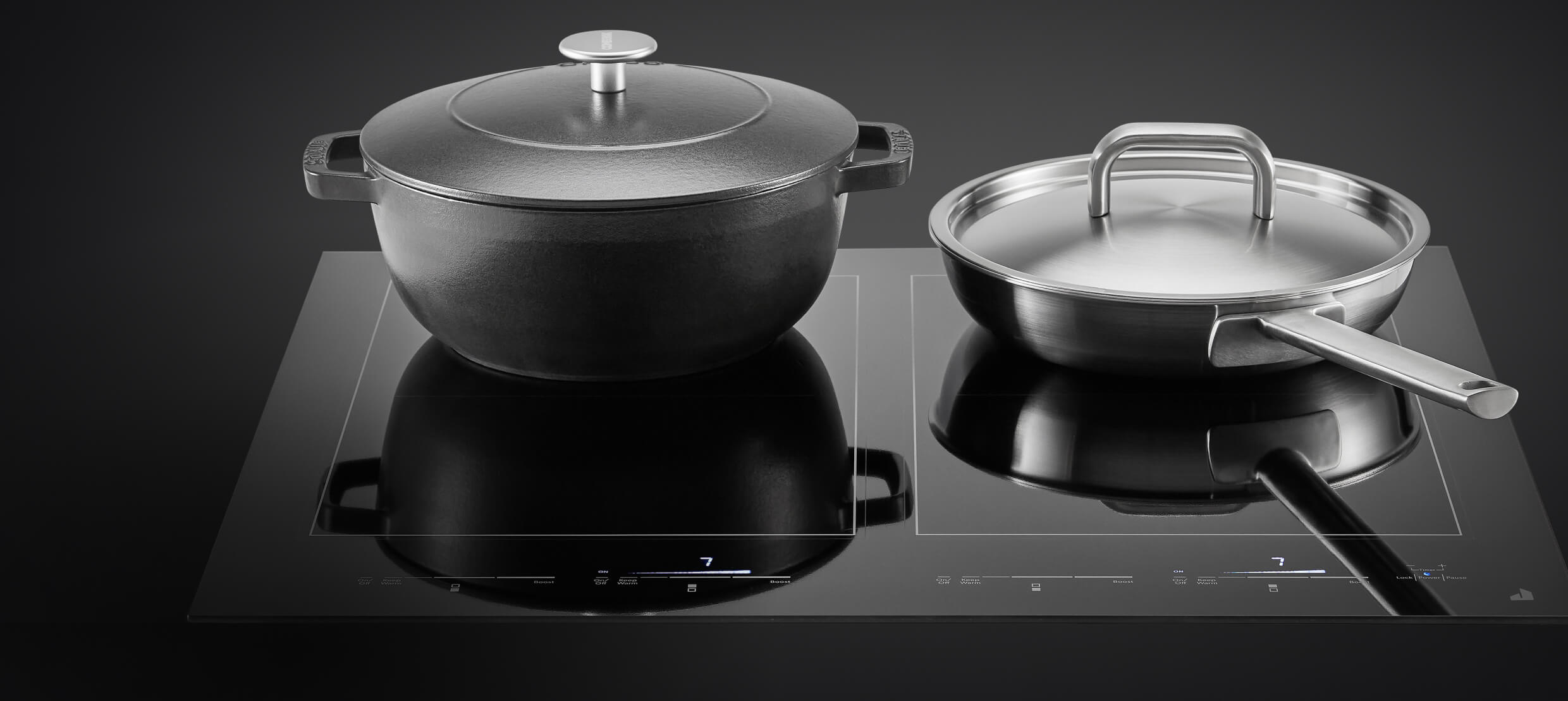 A pot and pan on an induction cooktop. A pot and pan on an induction cooktop.