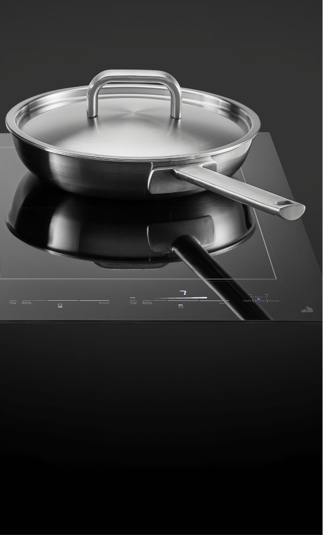 A pot and pan on an induction cooktop. A pot and pan on an induction cooktop.