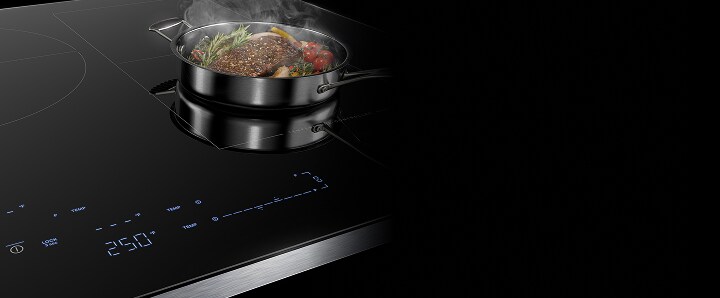 A steaming pan on an induction cooktop.