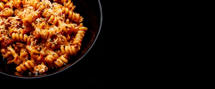 Plated food on a black surface.