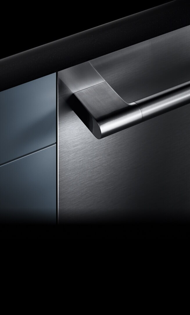A dishwasher front and handle installed into a cabinet, showing off the fully flush design.