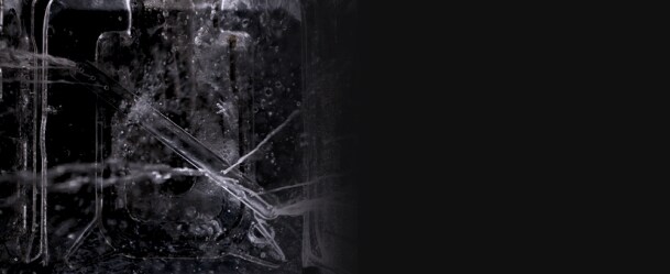 Closeup of water splashing a dish inside a dishwasher.