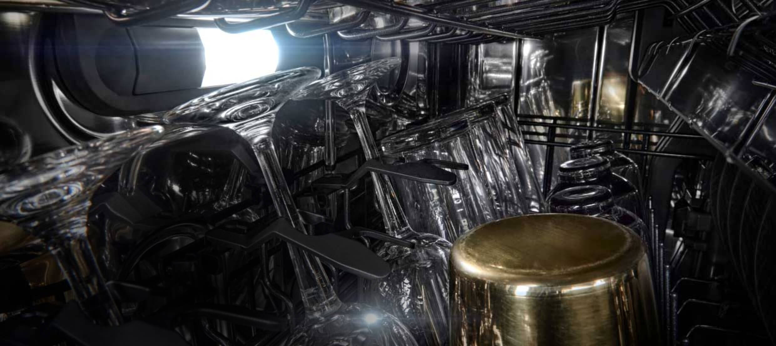 Wine glasses and tall water glasses in the middle rack of a dishwasher.