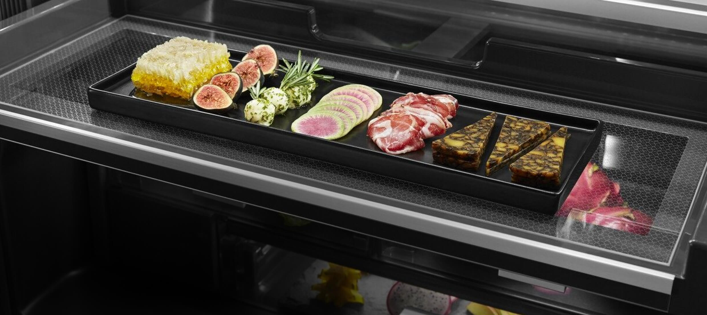 An open drawer showcasing fine ingredients in a freestanding refrigerator.  An open drawer showcasing fine ingredients in a freestanding refrigerator.