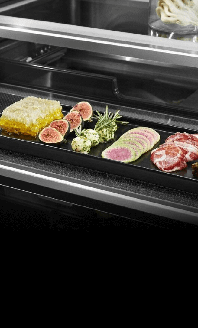 An open drawer showcasing fine ingredients in a freestanding refrigerator.  An open drawer showcasing fine ingredients in a freestanding refrigerator.