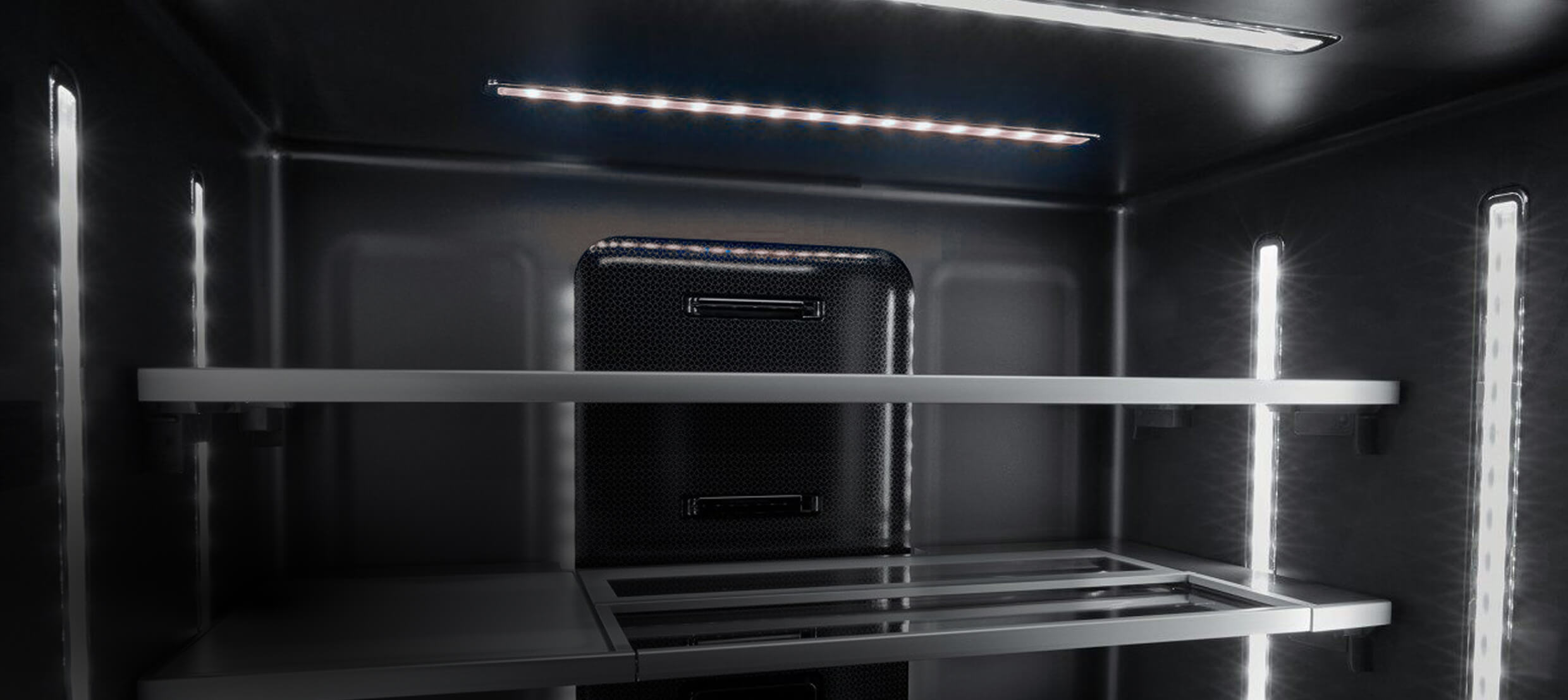 The illuminated Obsidian interior of a freestanding refrigerator.