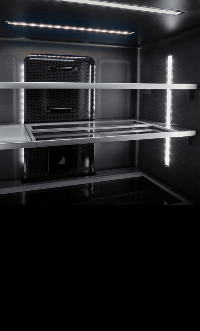 The illuminated Obsidian interior of a freestanding refrigerator.