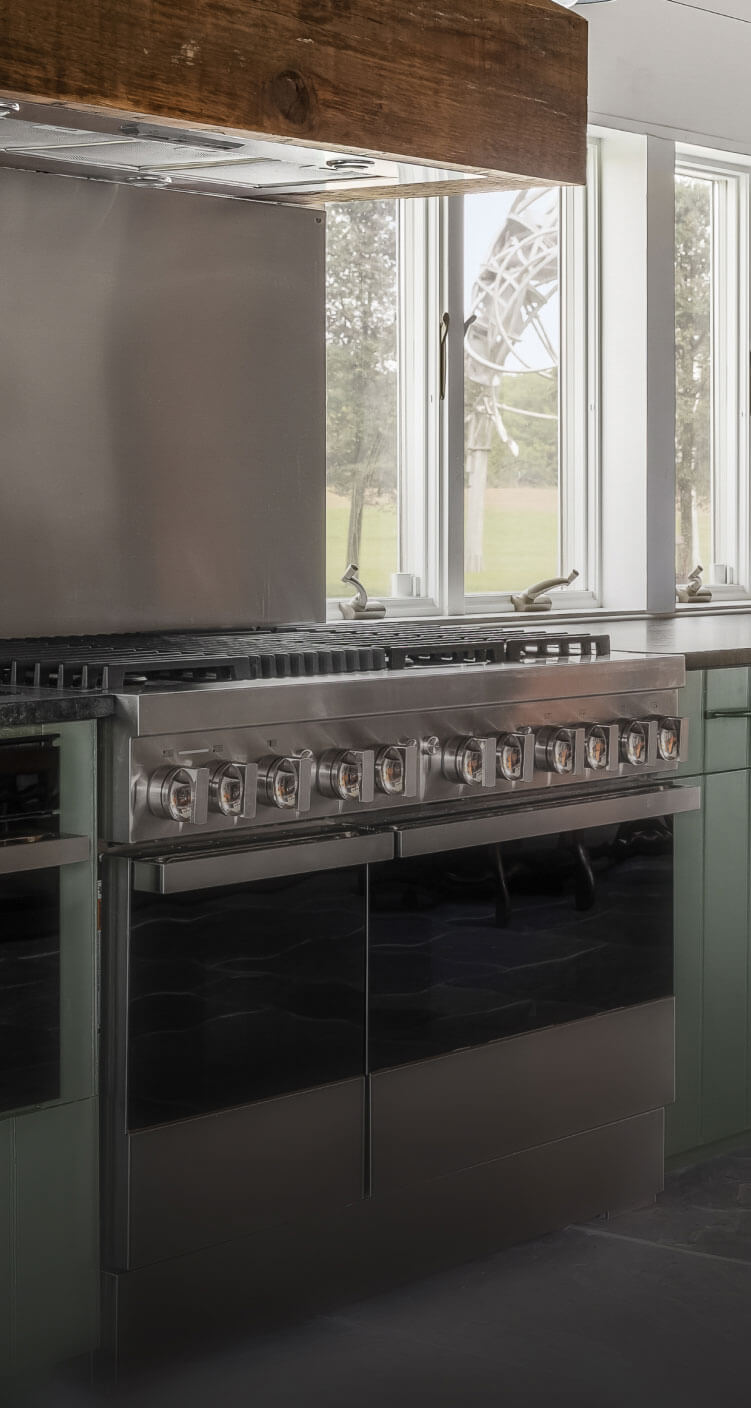 A JennAir® NOIR™ Dual-Fuel Range in a high-end kitchen.