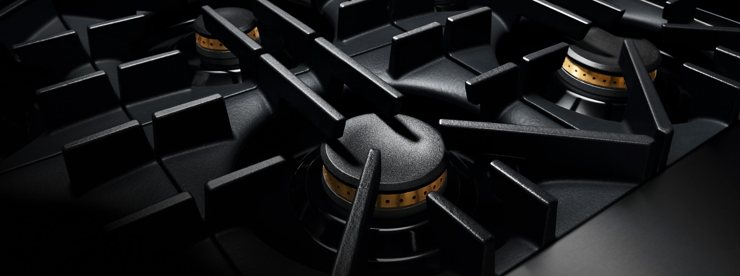 A close up of the geometric grates of a RISE™ Rangetop.