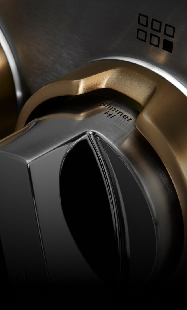 Closeup of the LED lighting around gas rangetop knobs.