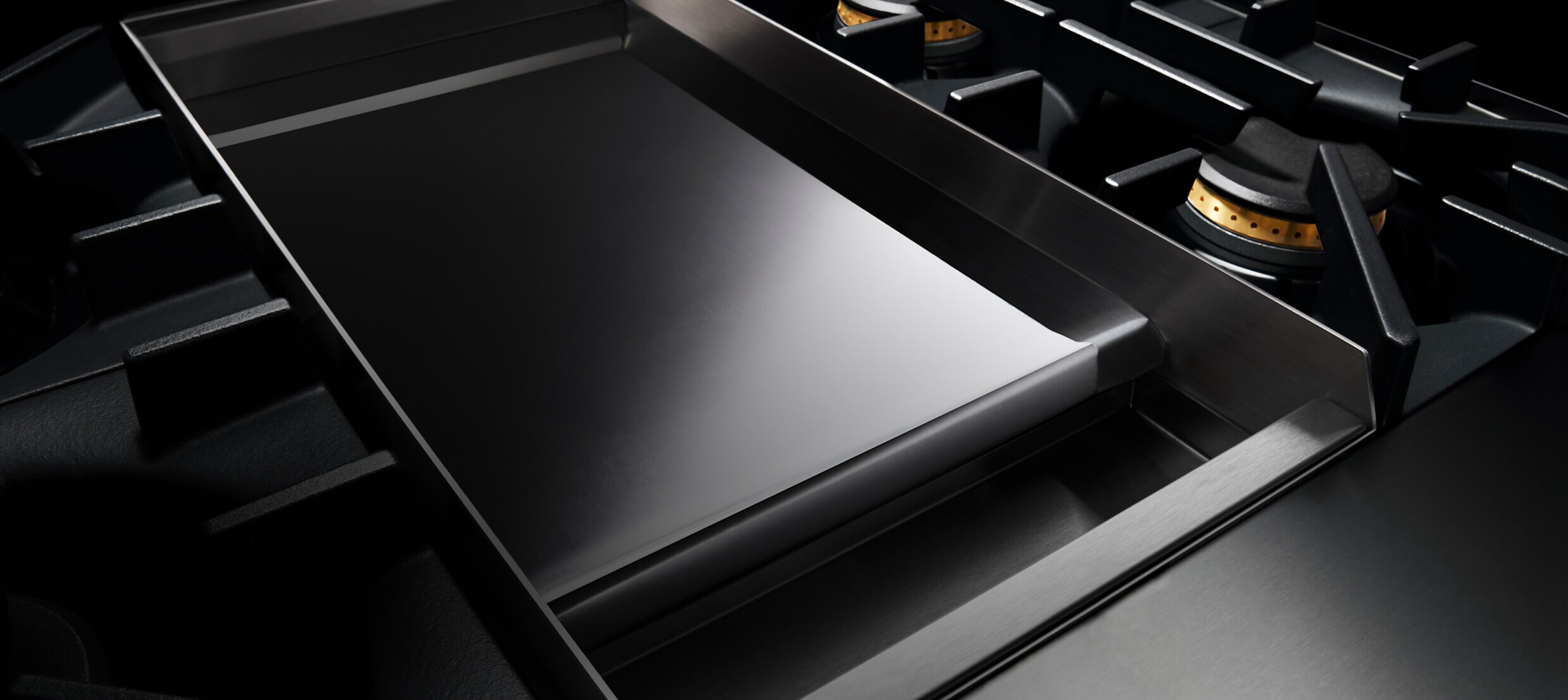 A Chrome-Infused Griddle on a gas rangetop.