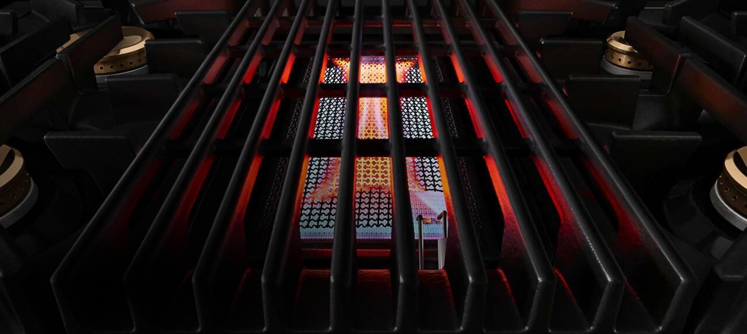 The cast iron grill section of a gas rangetop.