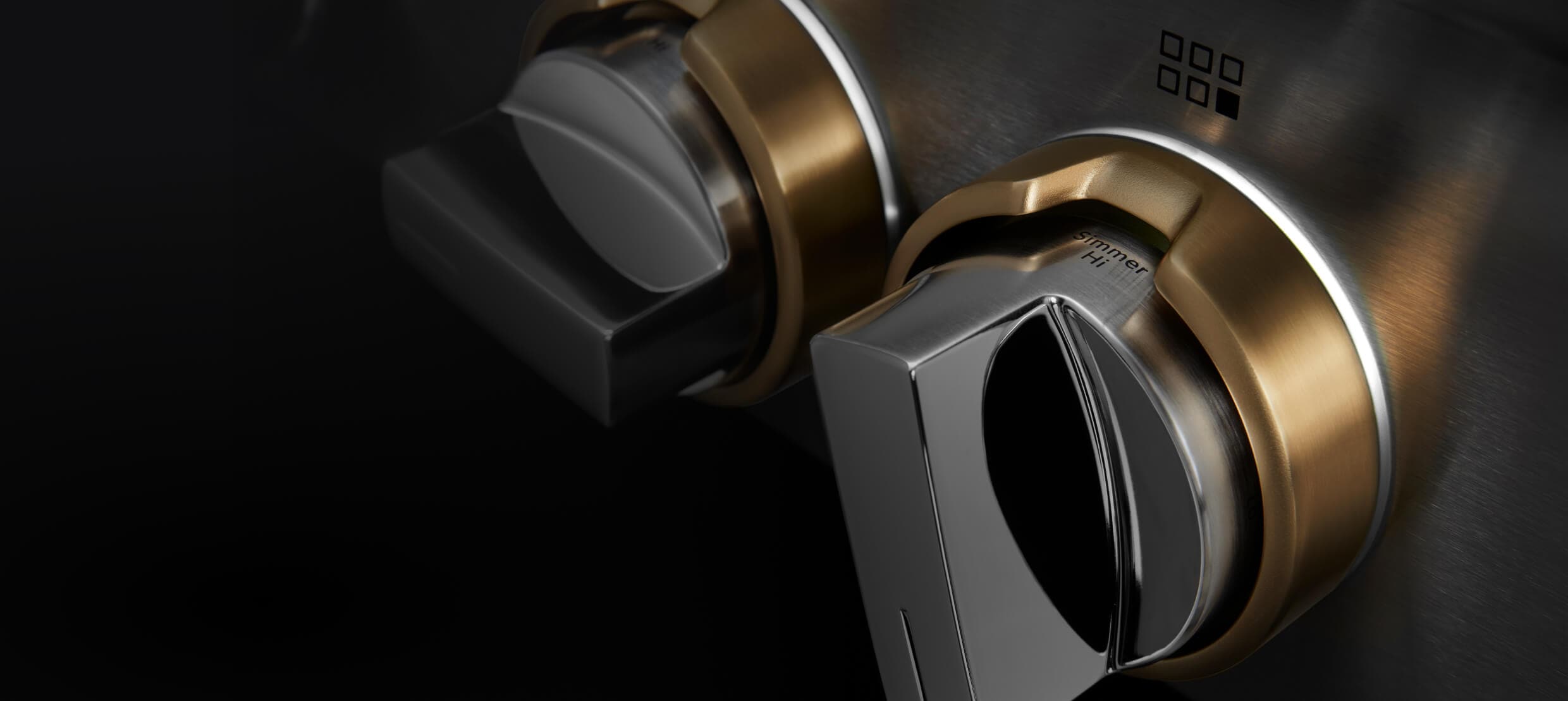 Closeup of the LED lighting around gas rangetop knobs.