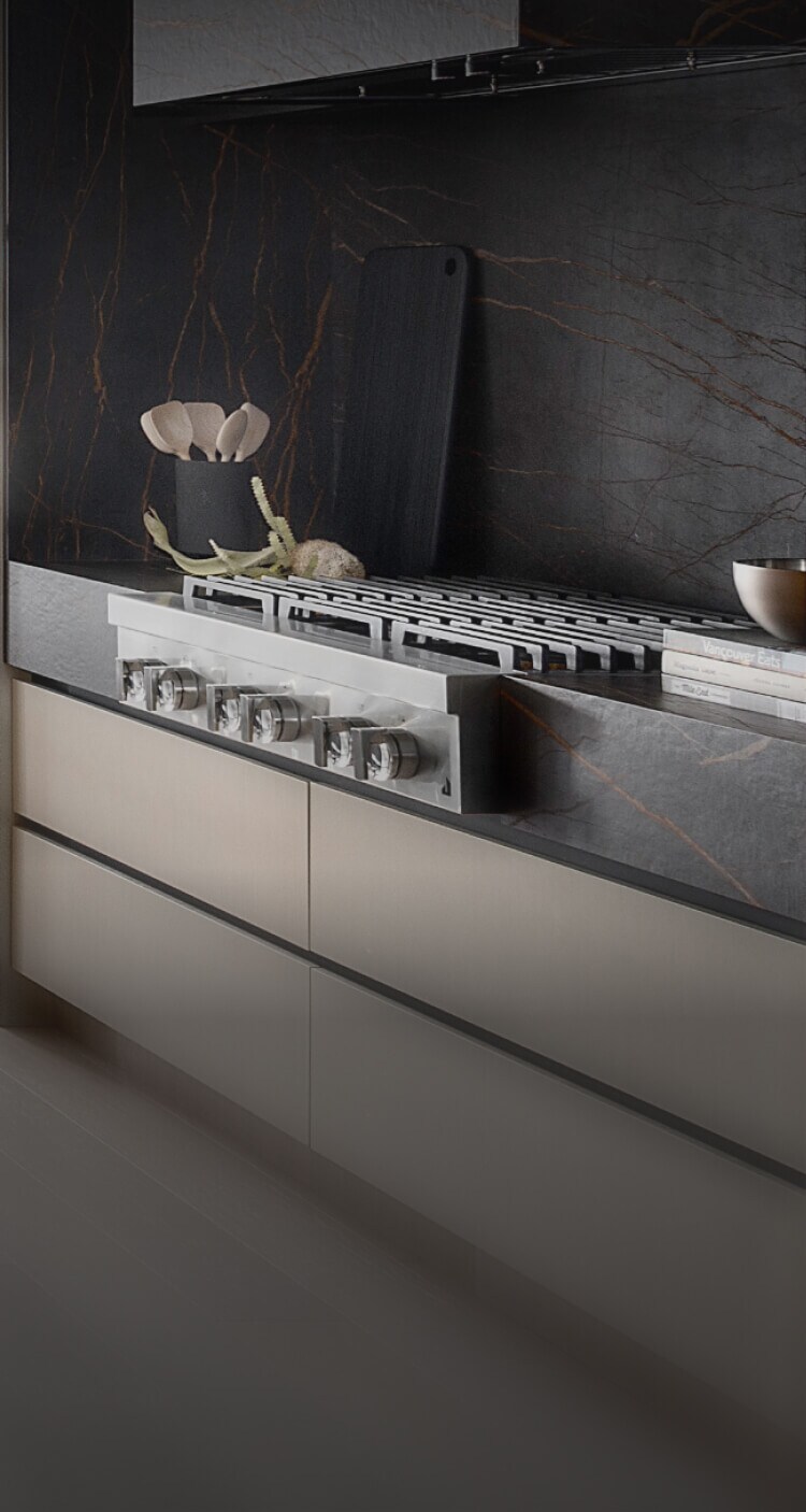 A JennAir® Gas Rangetop in a light-colored kitchen with dark accents.