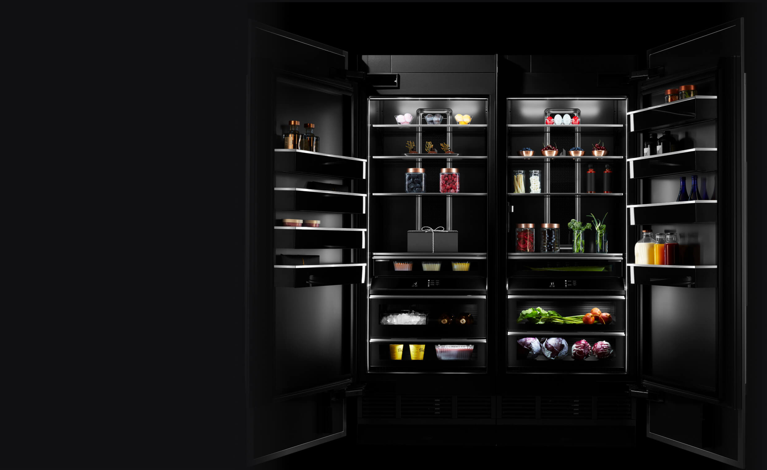 A pair of open JennAir® Columns with an Obsidian Interior, propped with vibrant ingredients.