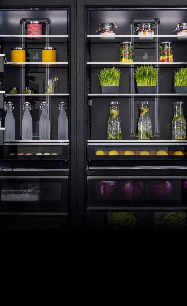 The interior of a pair of column refrigerators, showing off the lighting.