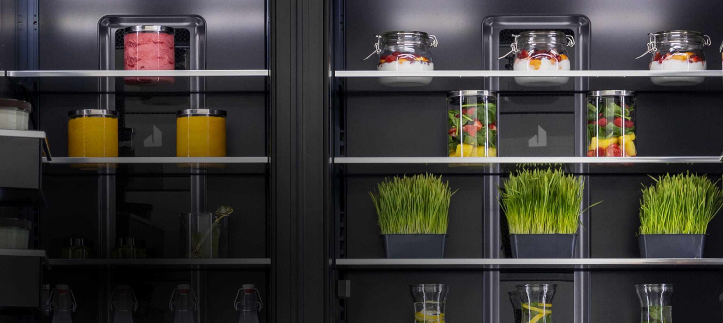 The interior of a pair of column refrigerators, showing off the lighting.