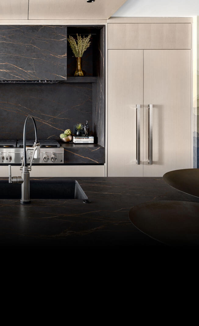 A beautiful modern kitchen featuring JennAir® appliances in panel-ready and NOIR™ Designs.