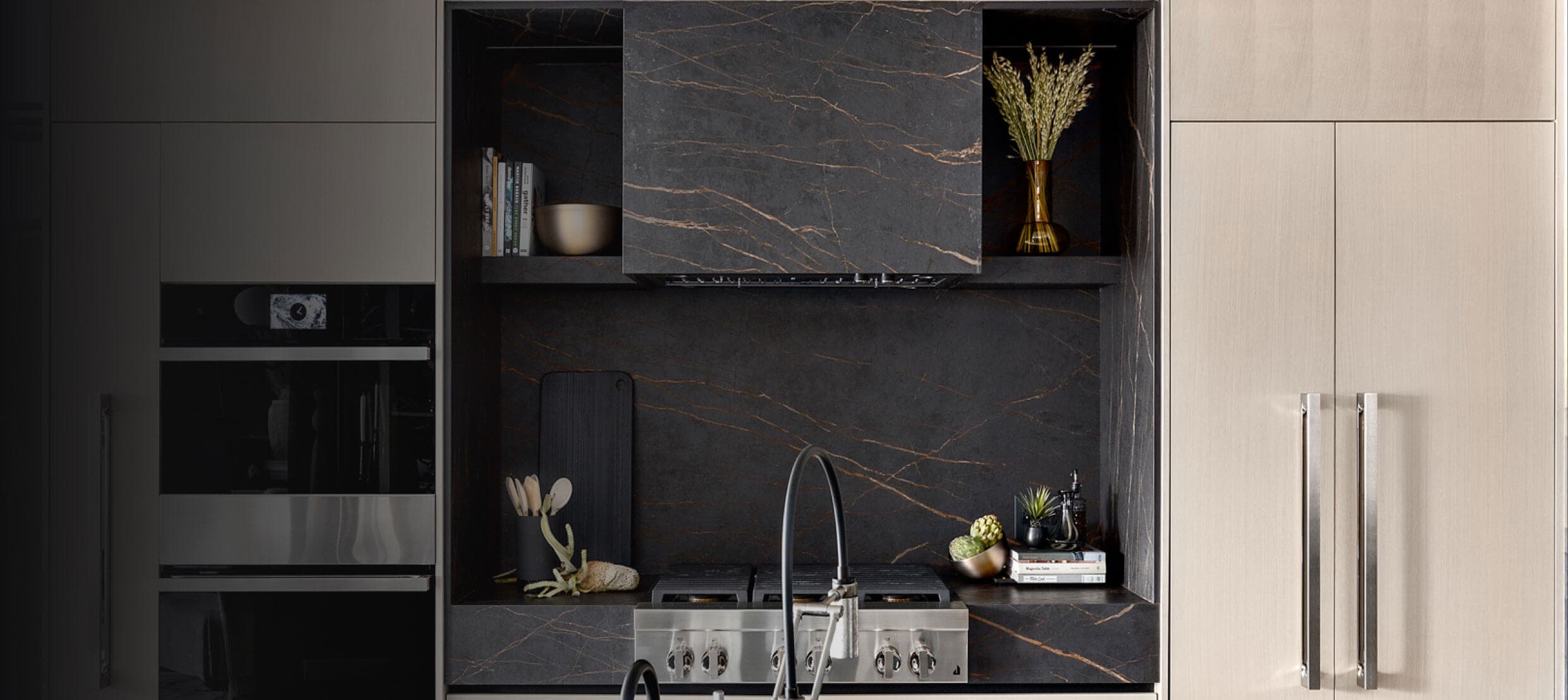 A beautiful modern kitchen featuring JennAir® appliances in panel-ready and NOIR™ Designs.