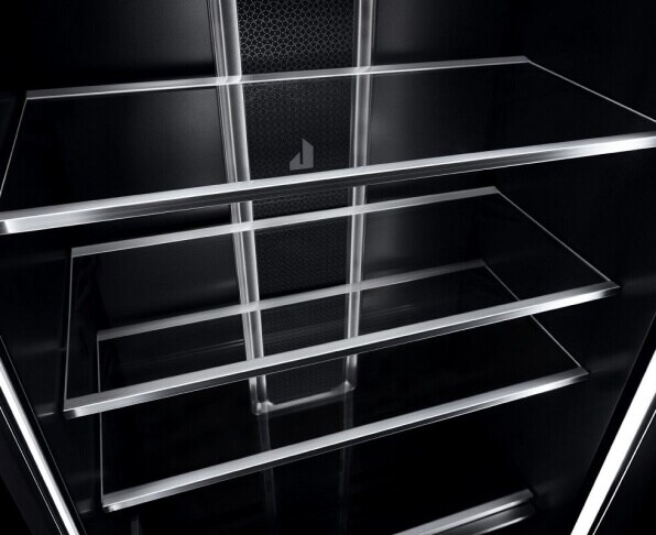 A close up of shelves in a JennAir® Column Refrigerator, showing the crystal-clear glass and metal materials.
