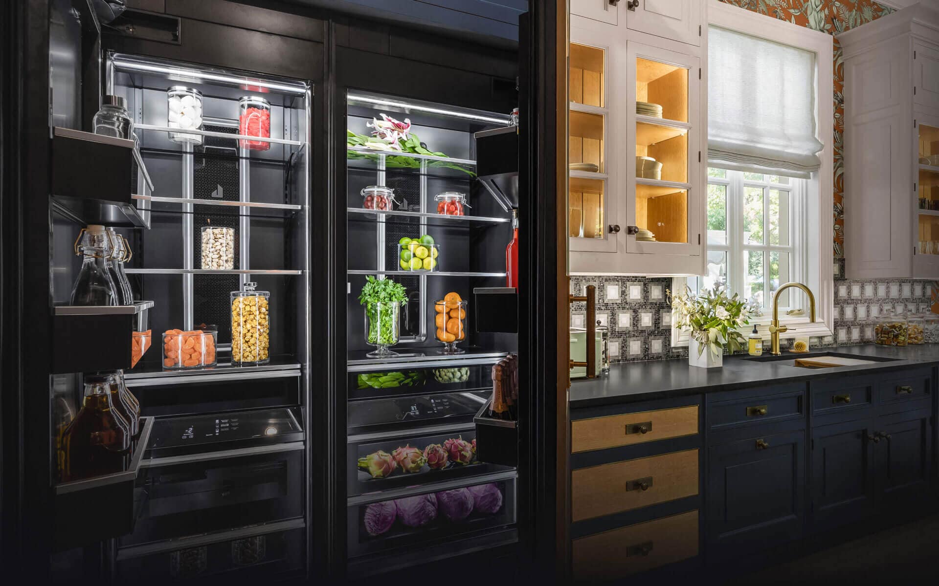 A real kitchen with white and blue kitchens featuring JennAir® appliances.