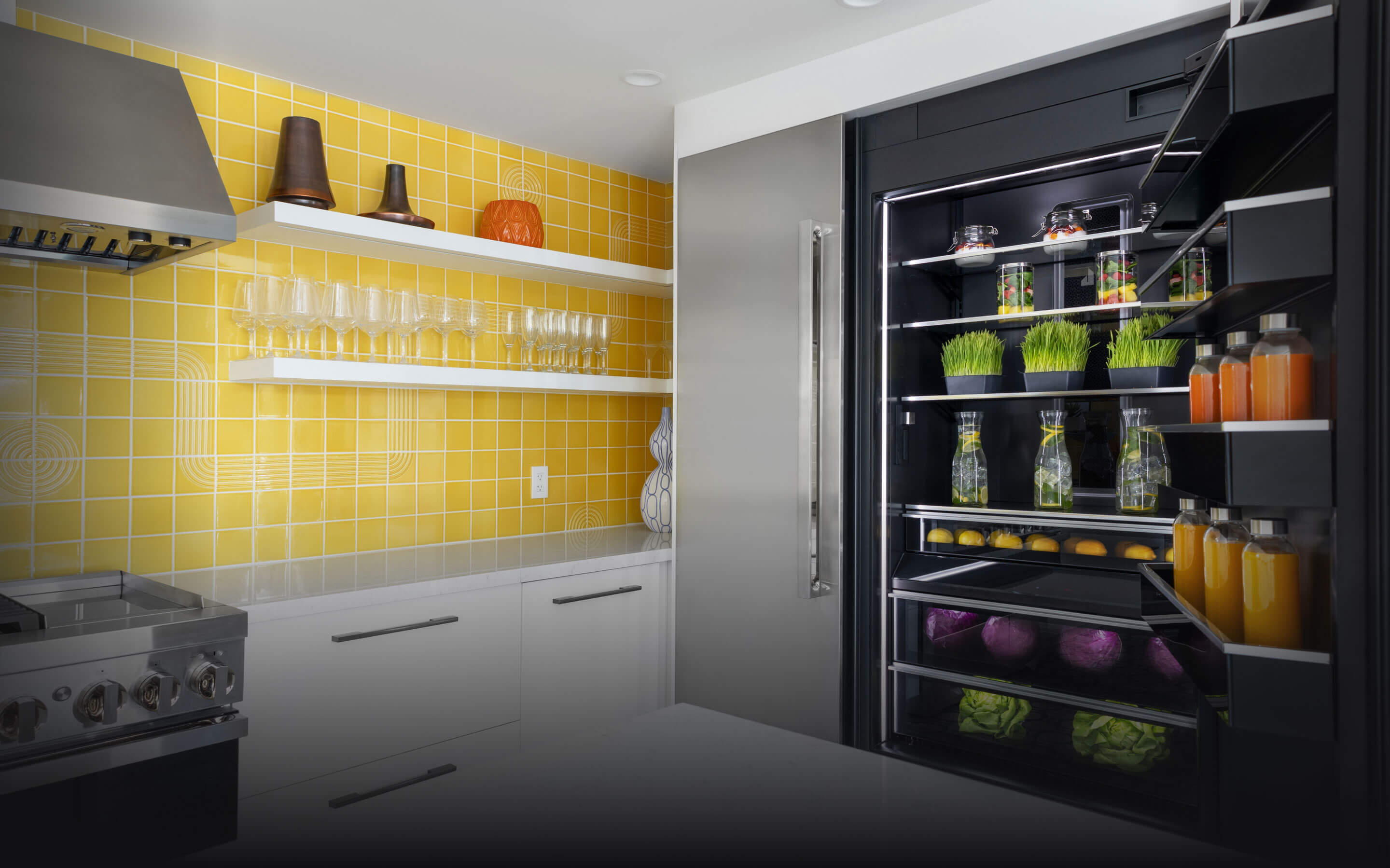 A bold yellow kitchen featuring NOIR™ appliances.