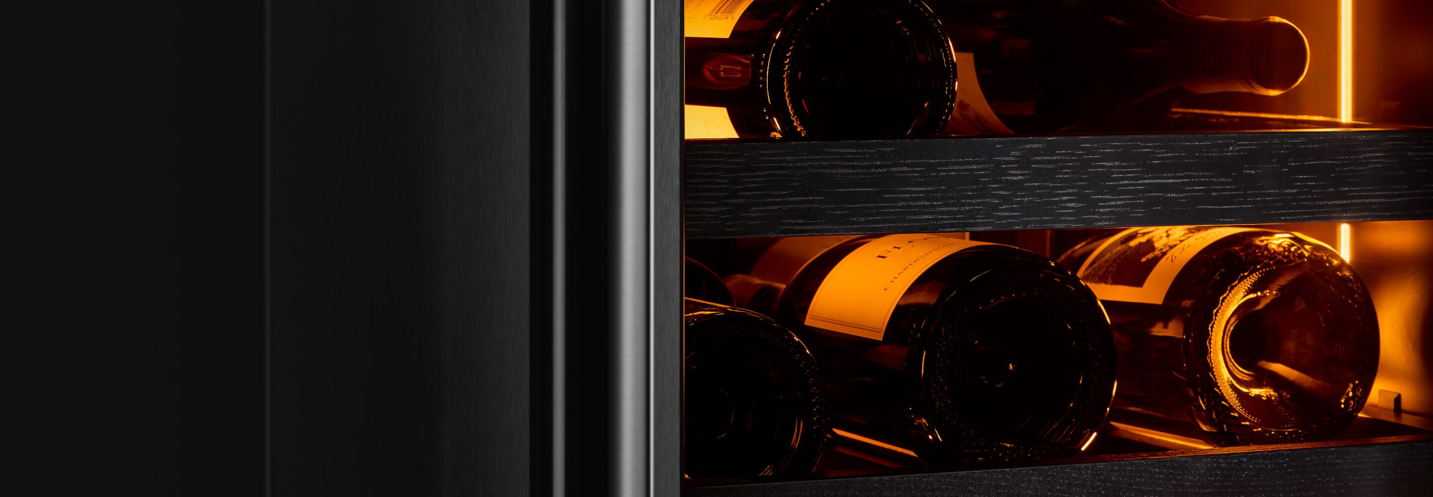 The interior of a wine column featuring wine bottles bathed in Ambra Lighting.