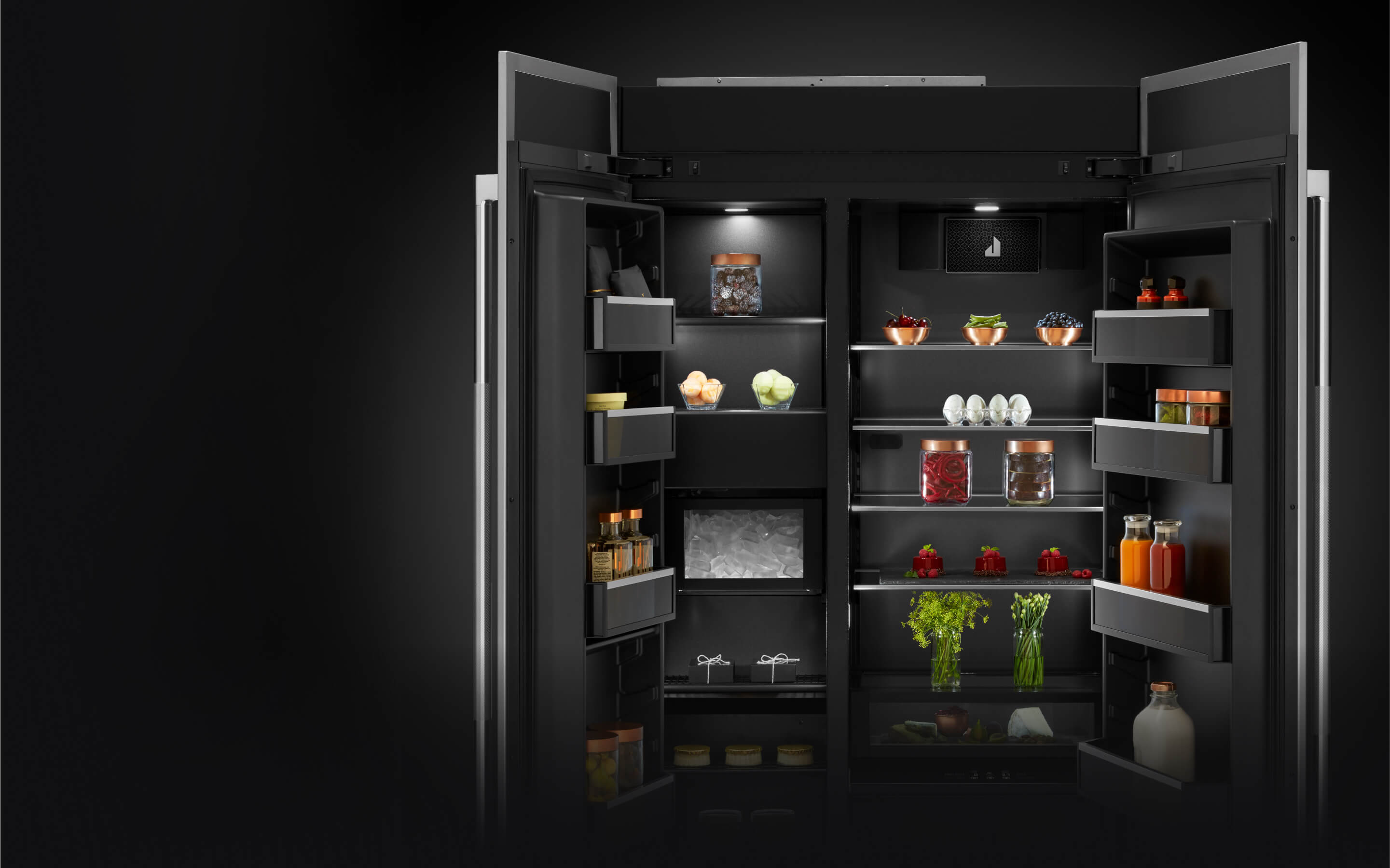 The rich dark interior of a JennAir® Side-By-Side Built-In Refrigerator.