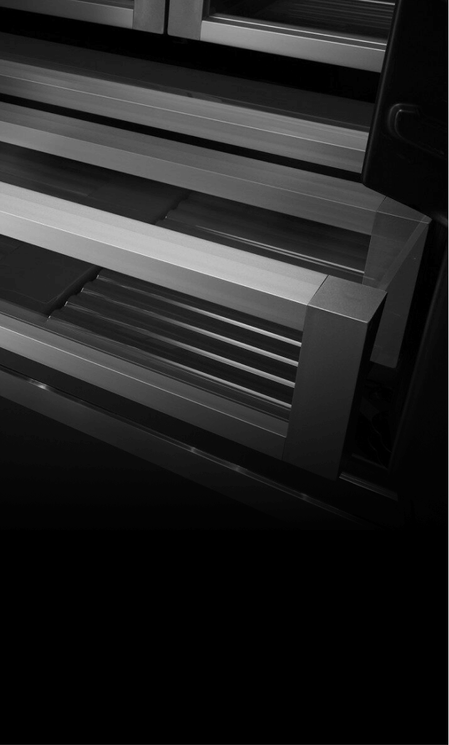 A crisper drawer in a JennAir® built-in refrigerator, slightly open.