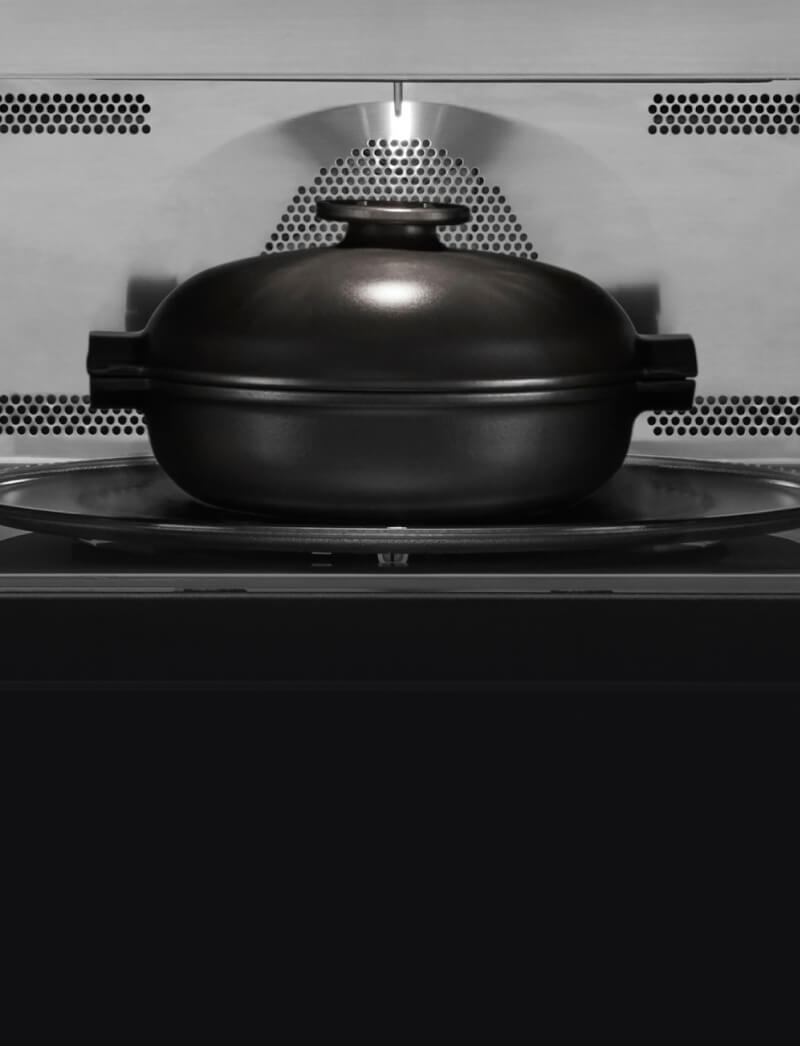 A covered, microwave-safe container inside a microwave.