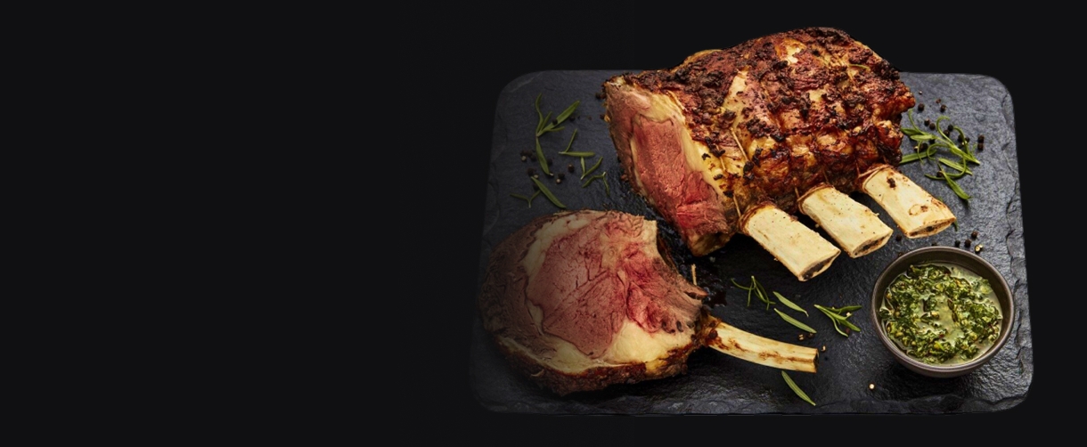 A crown roast on a slate plate.