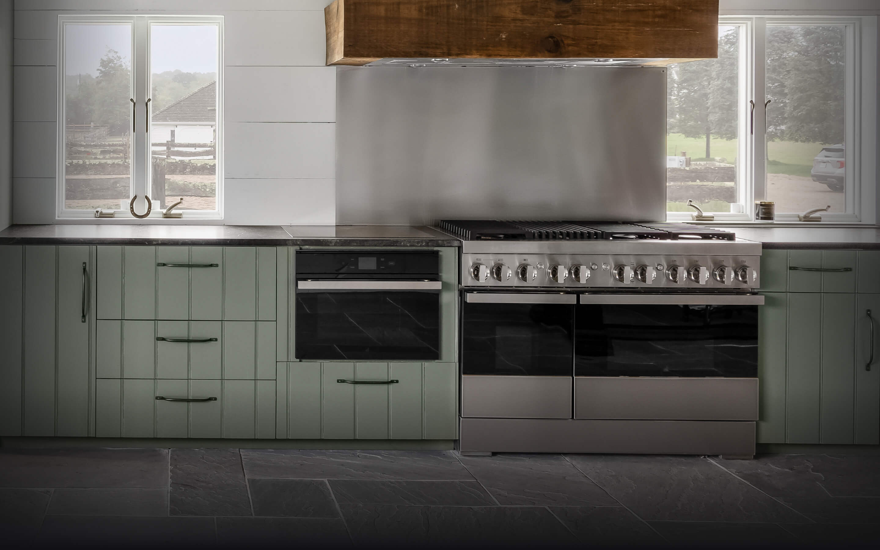 A JennAir® NOIR™ Dual-Fuel Range and Steam Oven in a high-end kitchen. A JennAir® NOIR™ Dual-Fuel Range and Steam Oven in a high-end kitchen.