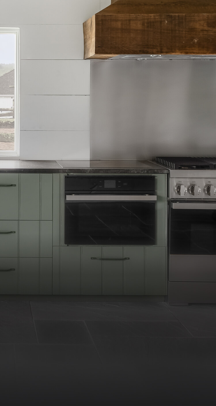 A JennAir® NOIR™ Dual-Fuel Range and Steam Oven in a high-end kitchen. A JennAir® NOIR™ Dual-Fuel Range and Steam Oven in a high-end kitchen.