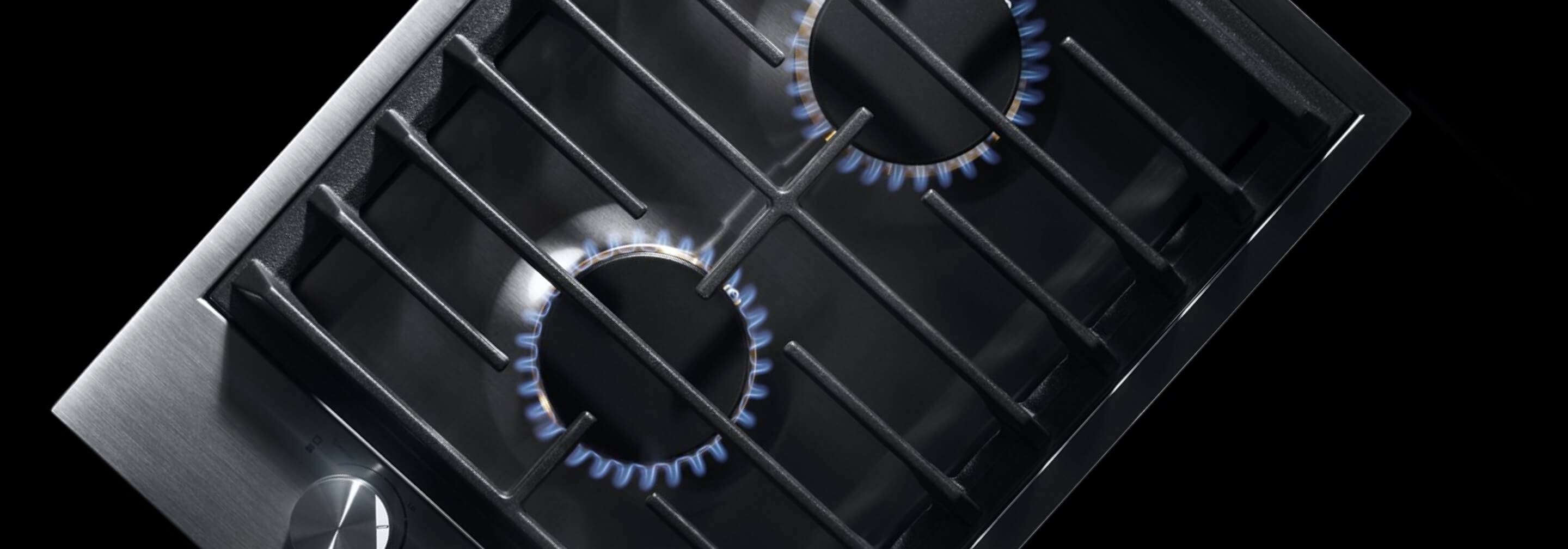 The 2-burner gas cooktop, with its burners lit.