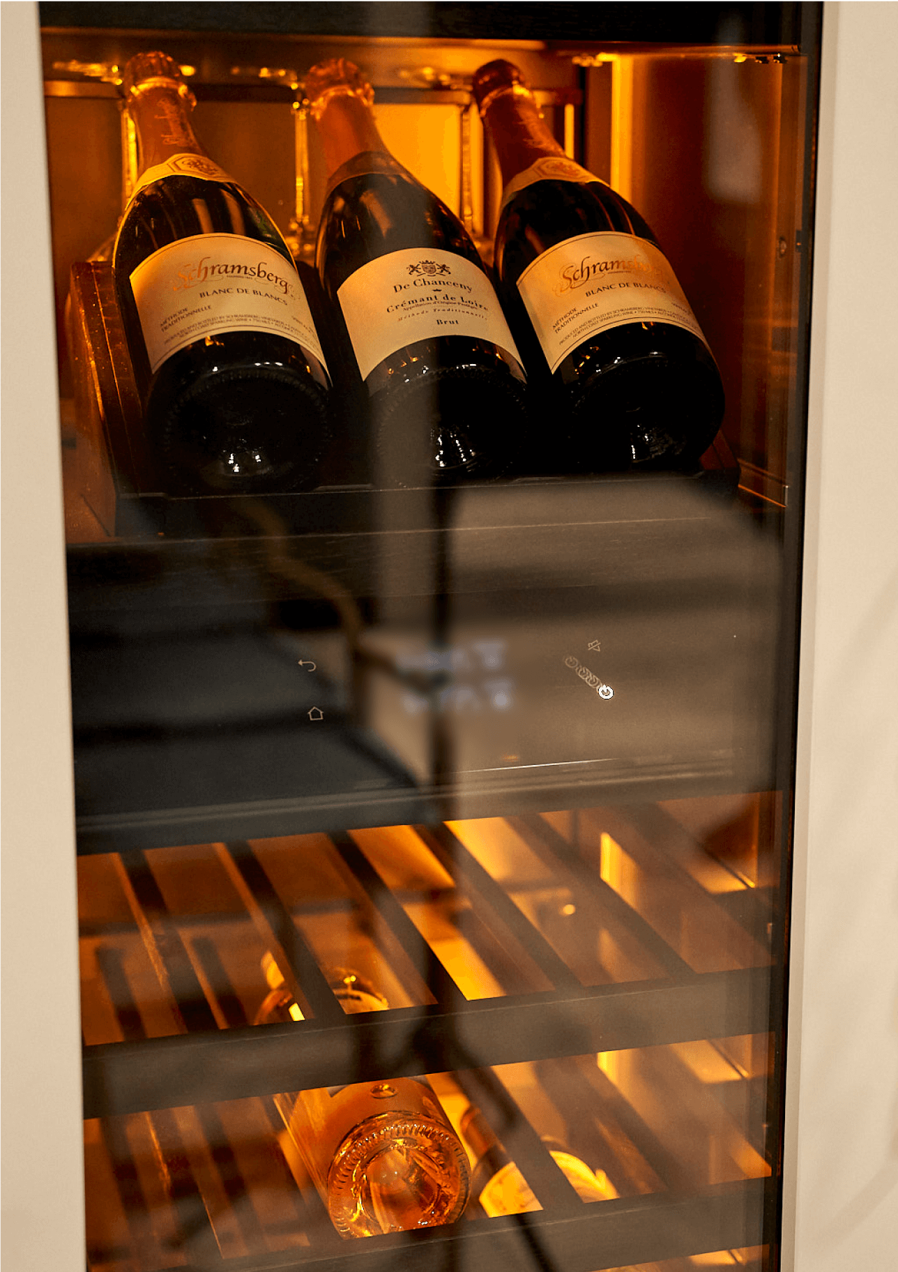 The interior of the new JennAir® wine column, awash in amber light.