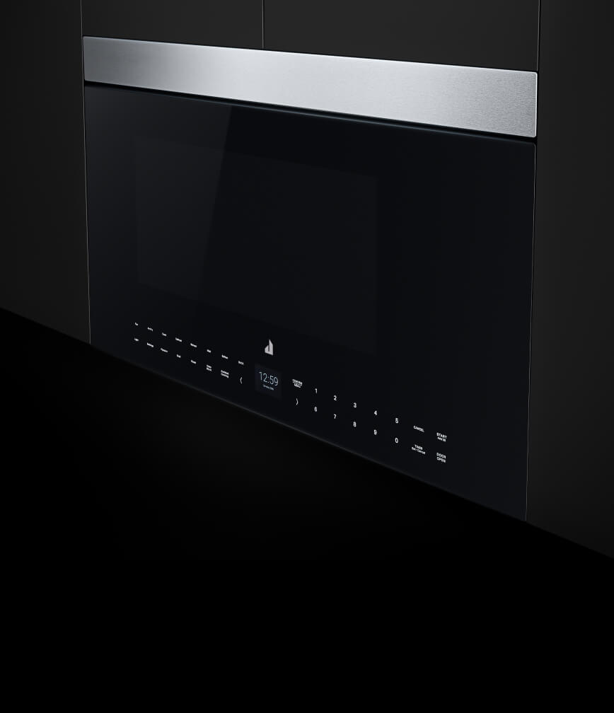 A flush oven hood microwave installed in a bank of black upper cabinets.