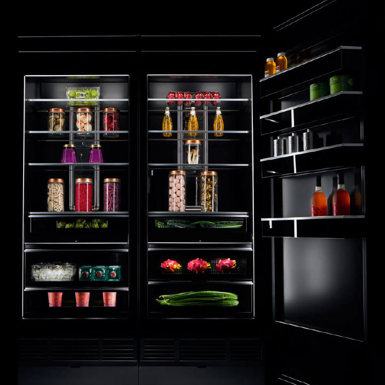 The interior of a JennAir refrigerator stocked with luxurious ingredients and fine foods.