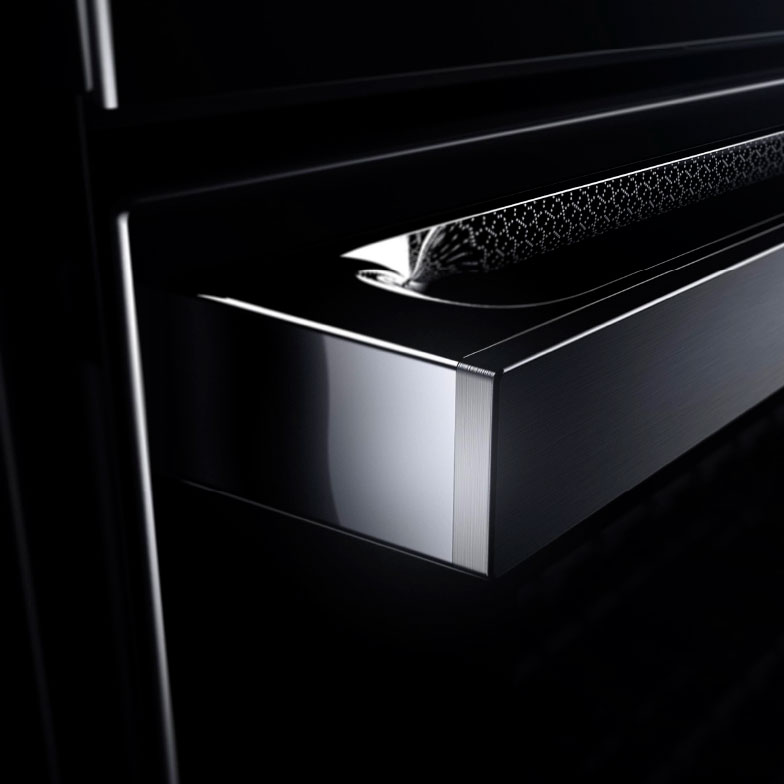 The etched lace detail of the NOIR™ Design Expression reflecting on a JennAir range. 