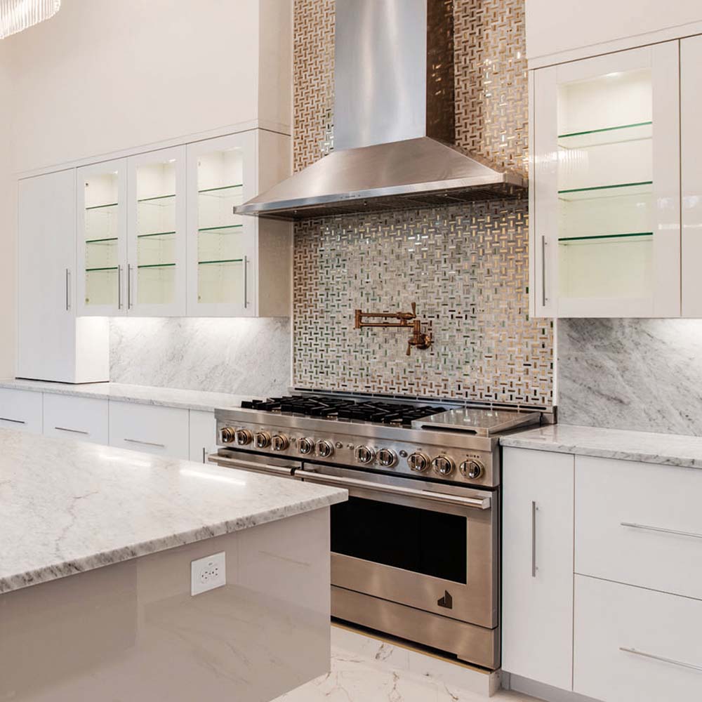A JennAir professional-style range and ventilation system in a bright kitchen. 