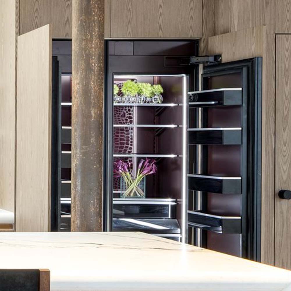 An open Burlesque refrigerator and freezer in a natural, modern kitchen.