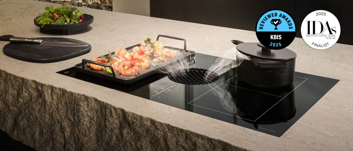 A JennAir Electric Downdraft Cooktop drawing steam from food cooking in a pan.