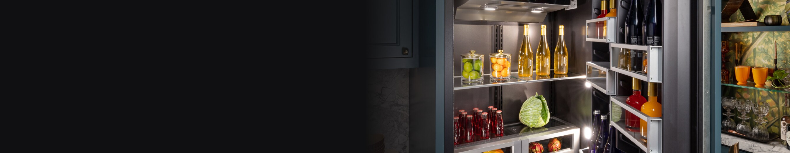 A mint-colored JennAir® Panel-Ready Refrigerator next to matching cabinets