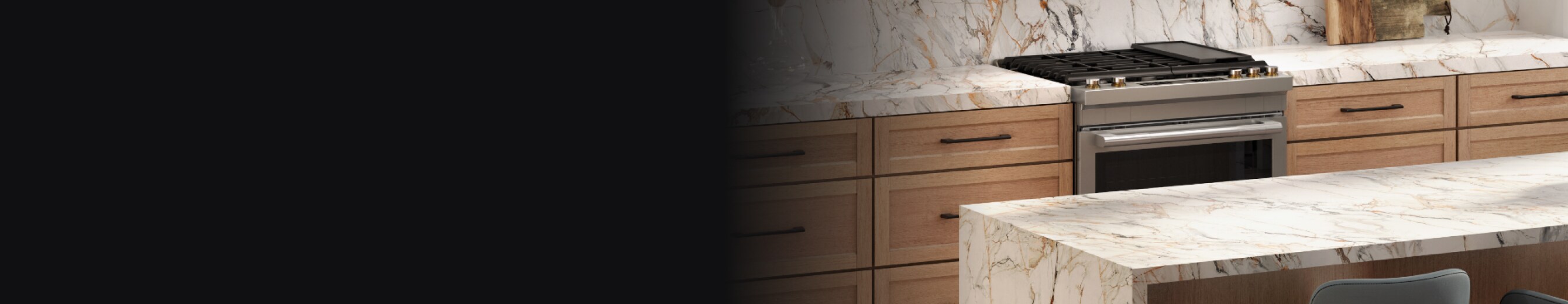 A JennAir® Slide-In Gas Range in a kitchen with marble countertops