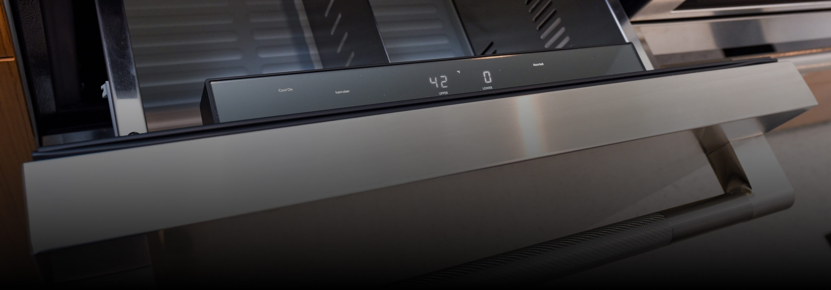 An open undercounter refrigerator drawer.