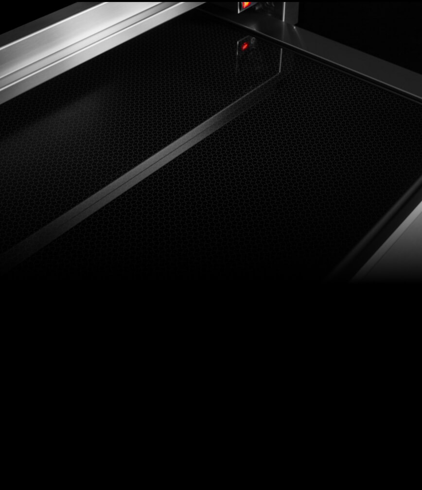 The interior of the warming drawer, displaying the black glass bottom.