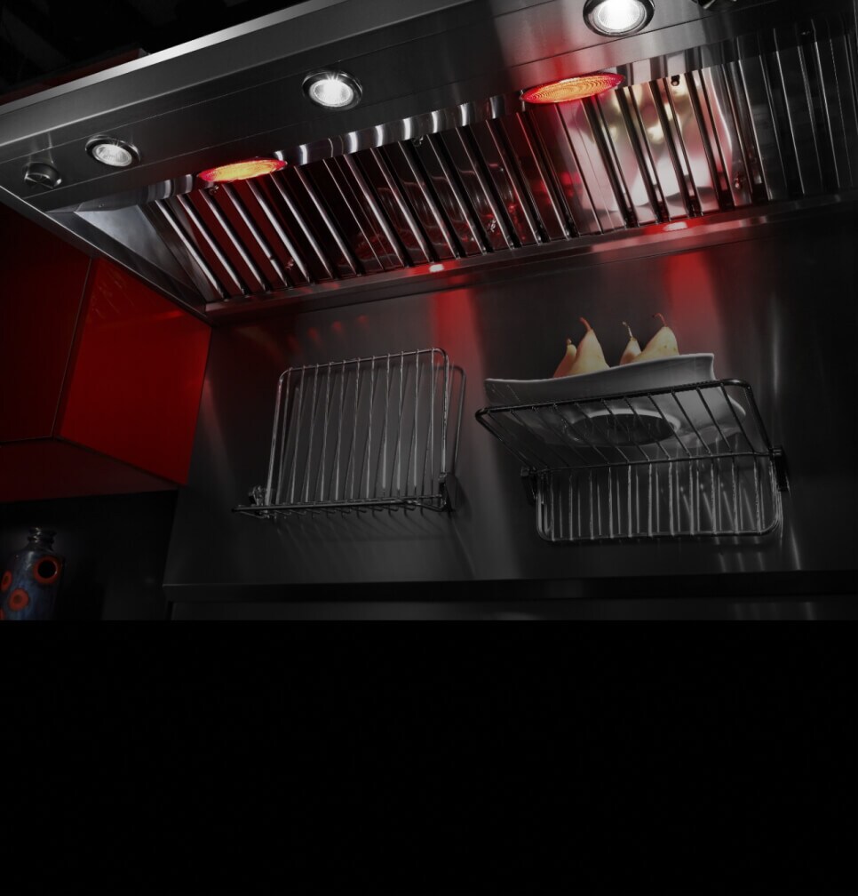 Warming lamps on a wall-mount ventilation hood.