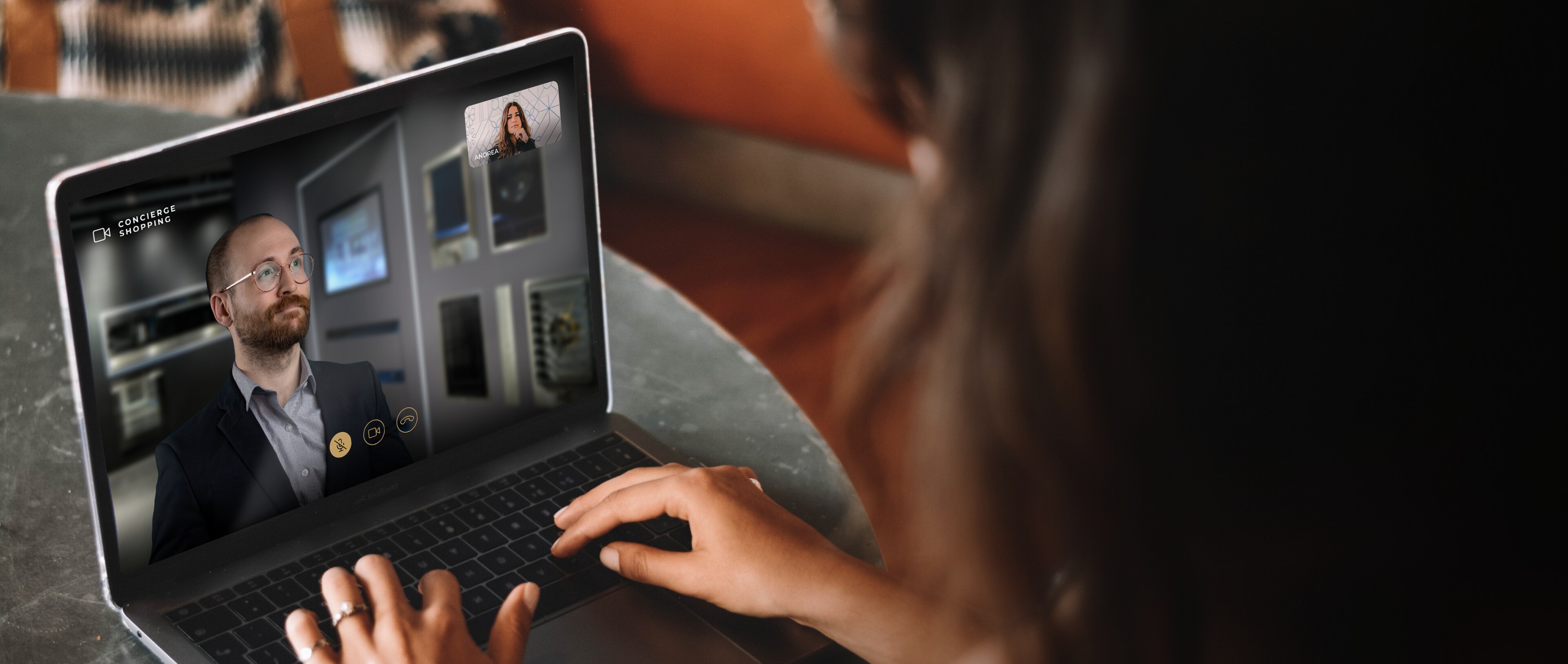 A person looking at a laptop during a video call.