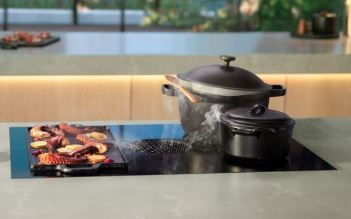 A downdraft induction cooktop in a modern, luxury kitchen.