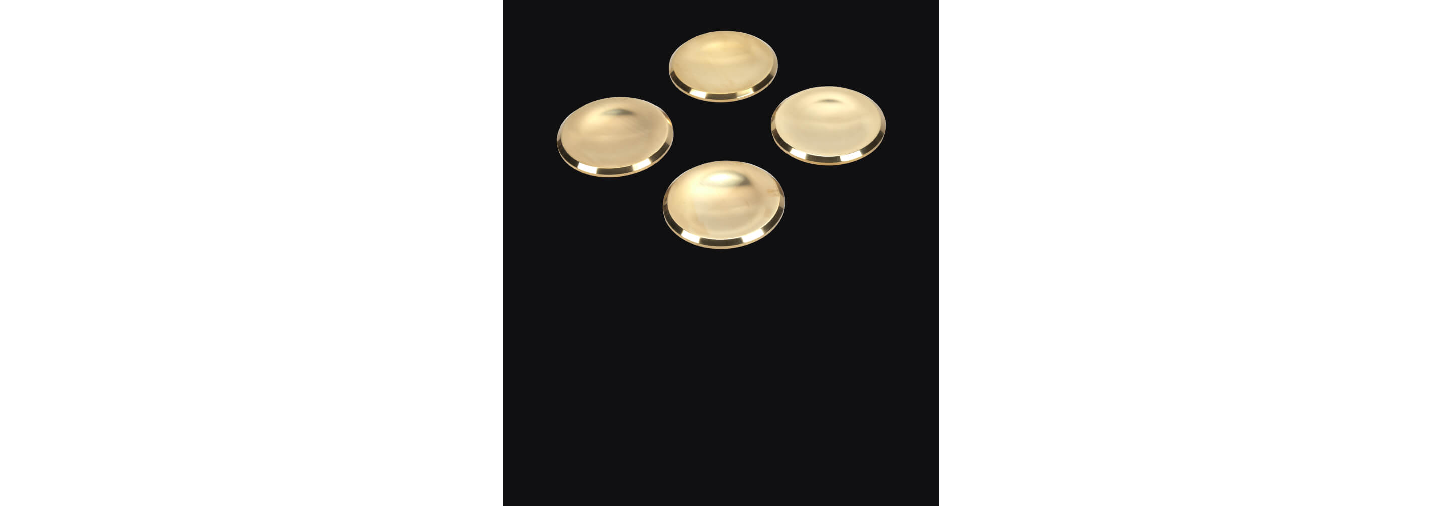 Brass burner caps isolated on a black background.